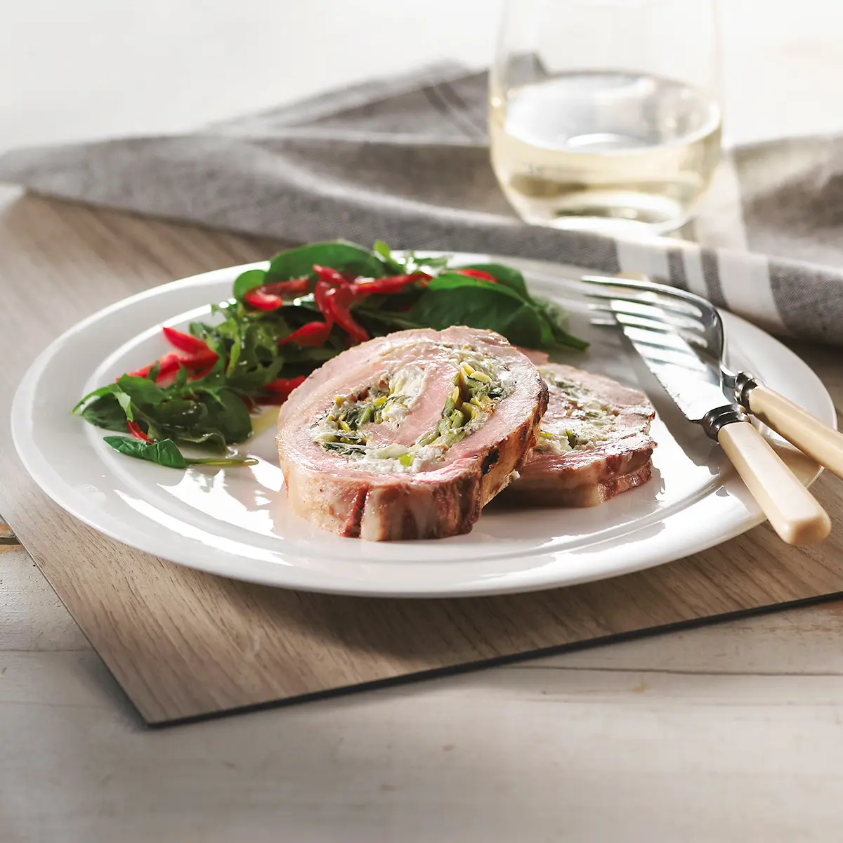 Grilled pork loin with leeks and goat cheese